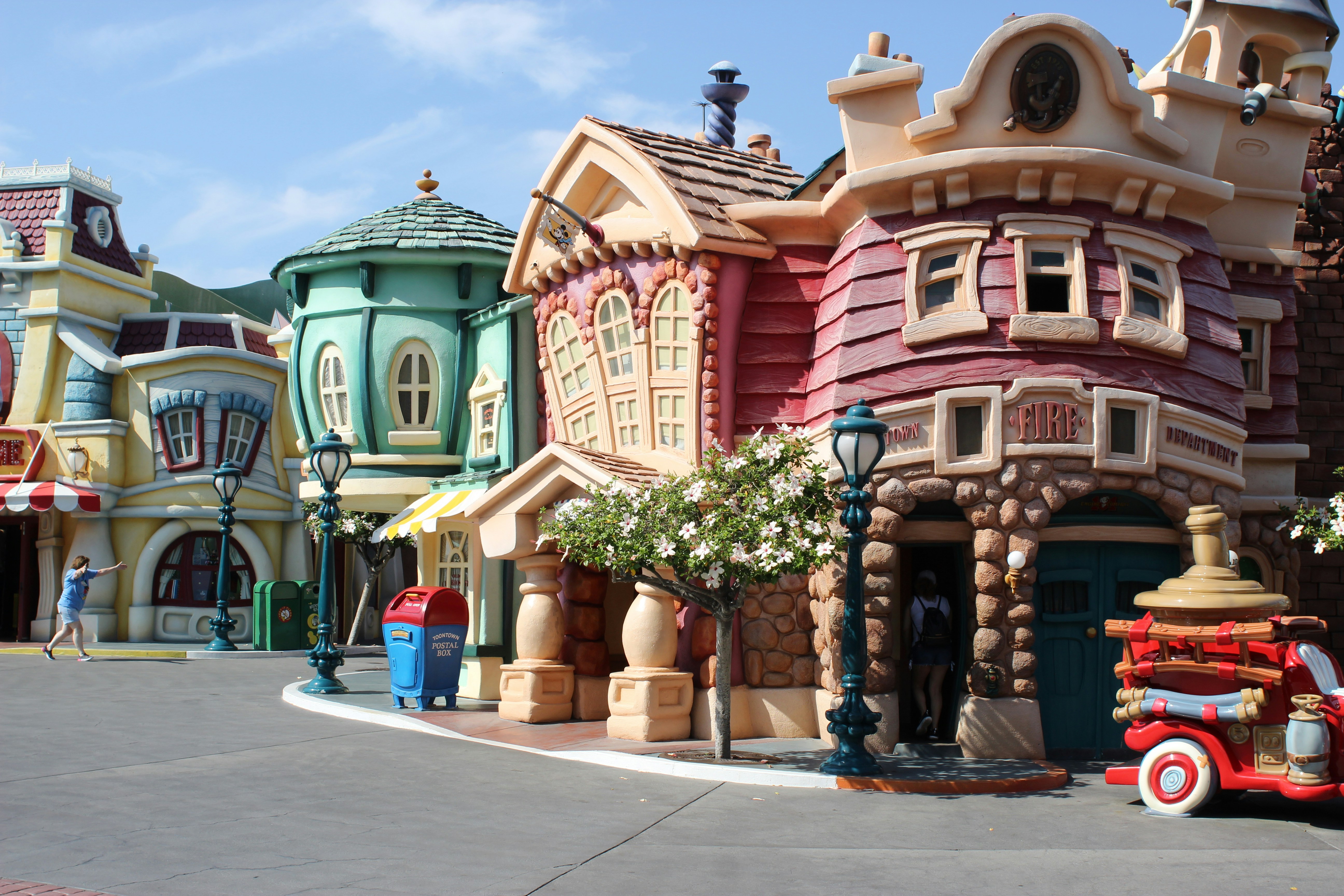 A colorful, whimsical street in a fantasy city neighborhood